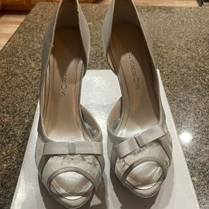 Caparros peep toe high heel with silver lace, never worn
